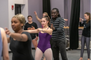 students working with choreographer Mustapha Braimah