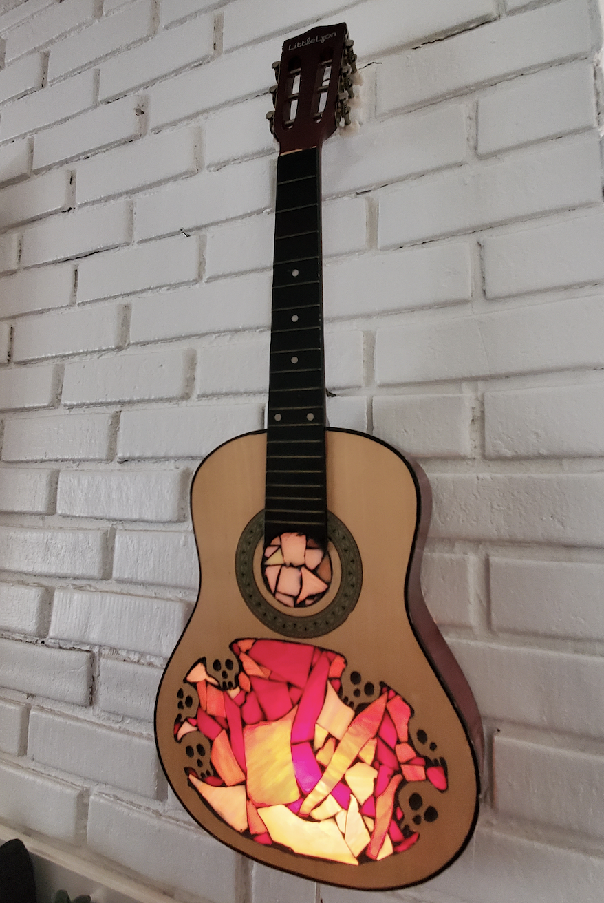 custom guitar hanging on wall