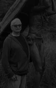 man standing by statue