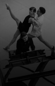 Two dancers in front of a piano at Akron Art Museum